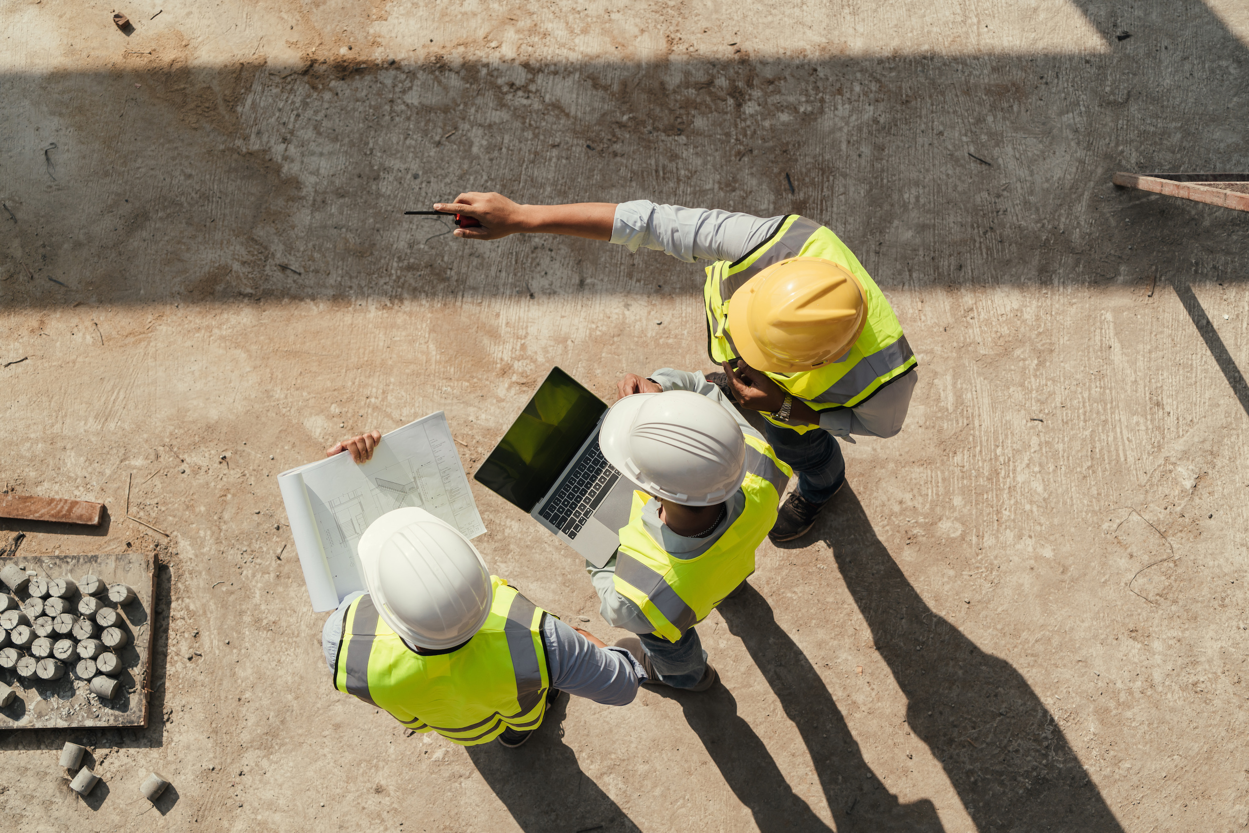 Top view, Team engineer building inspection use tablet computer and blueprint working at construction site. CORE Environmental Consulting Culture